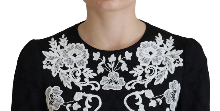 Elegant black A-line mini dress with lace trim