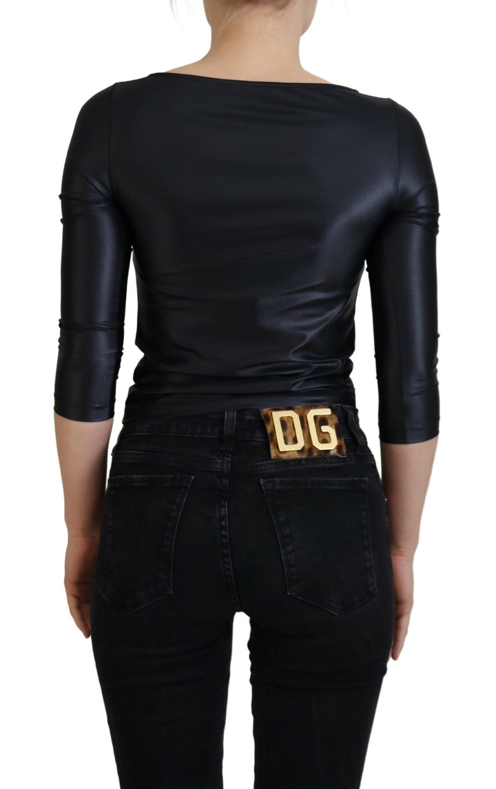 Elegant black top with 3/4 sleeves and gold decoration
