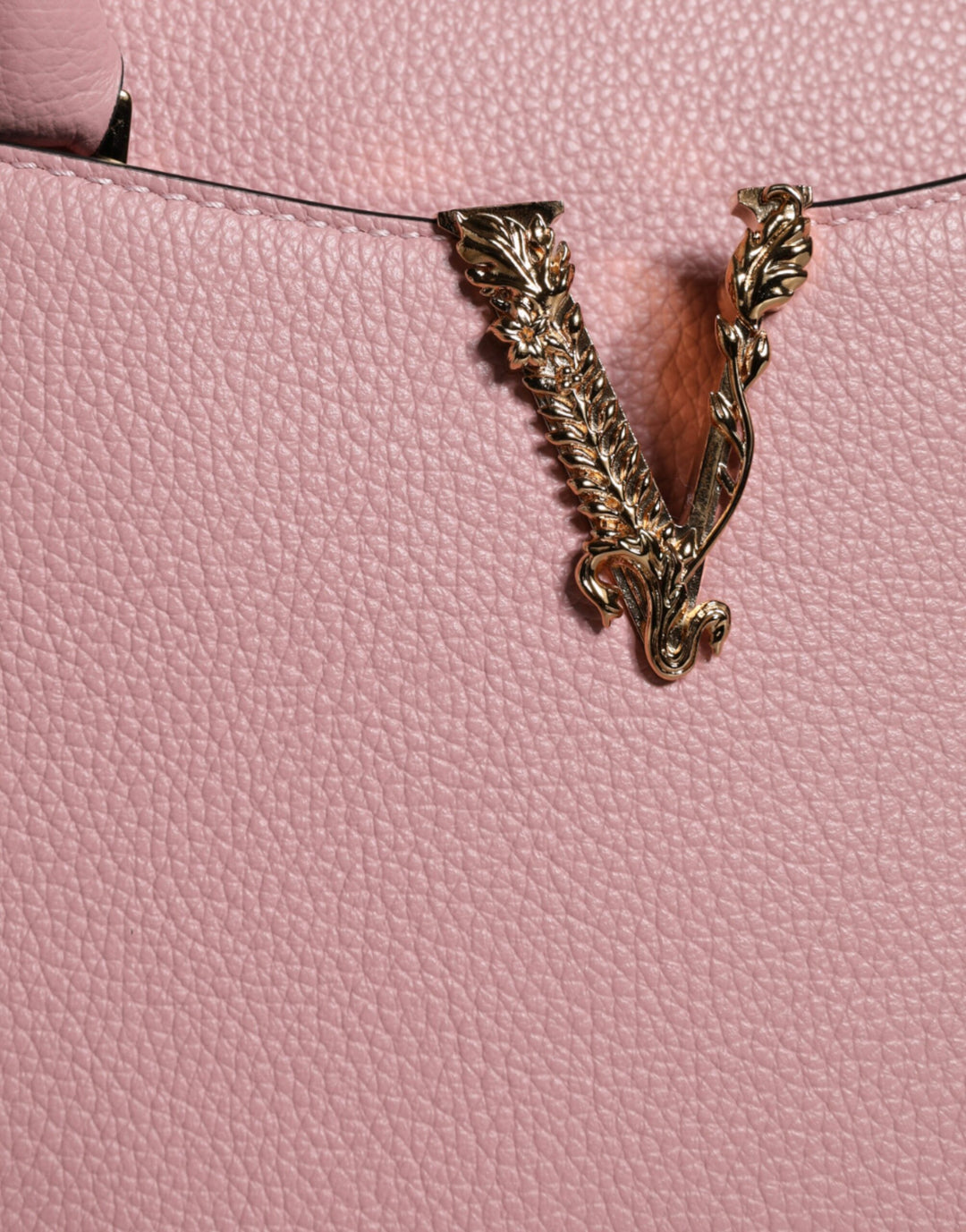 Pink crossbody bag with small handle made of grained calfskin