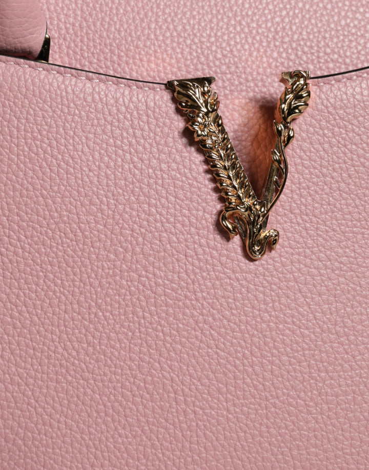 Pink crossbody bag with small handle made of grained calfskin