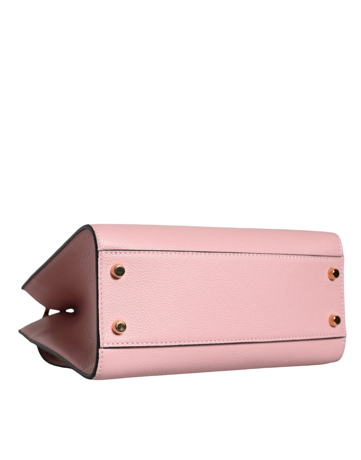 Pink crossbody bag with small handle made of grained calfskin